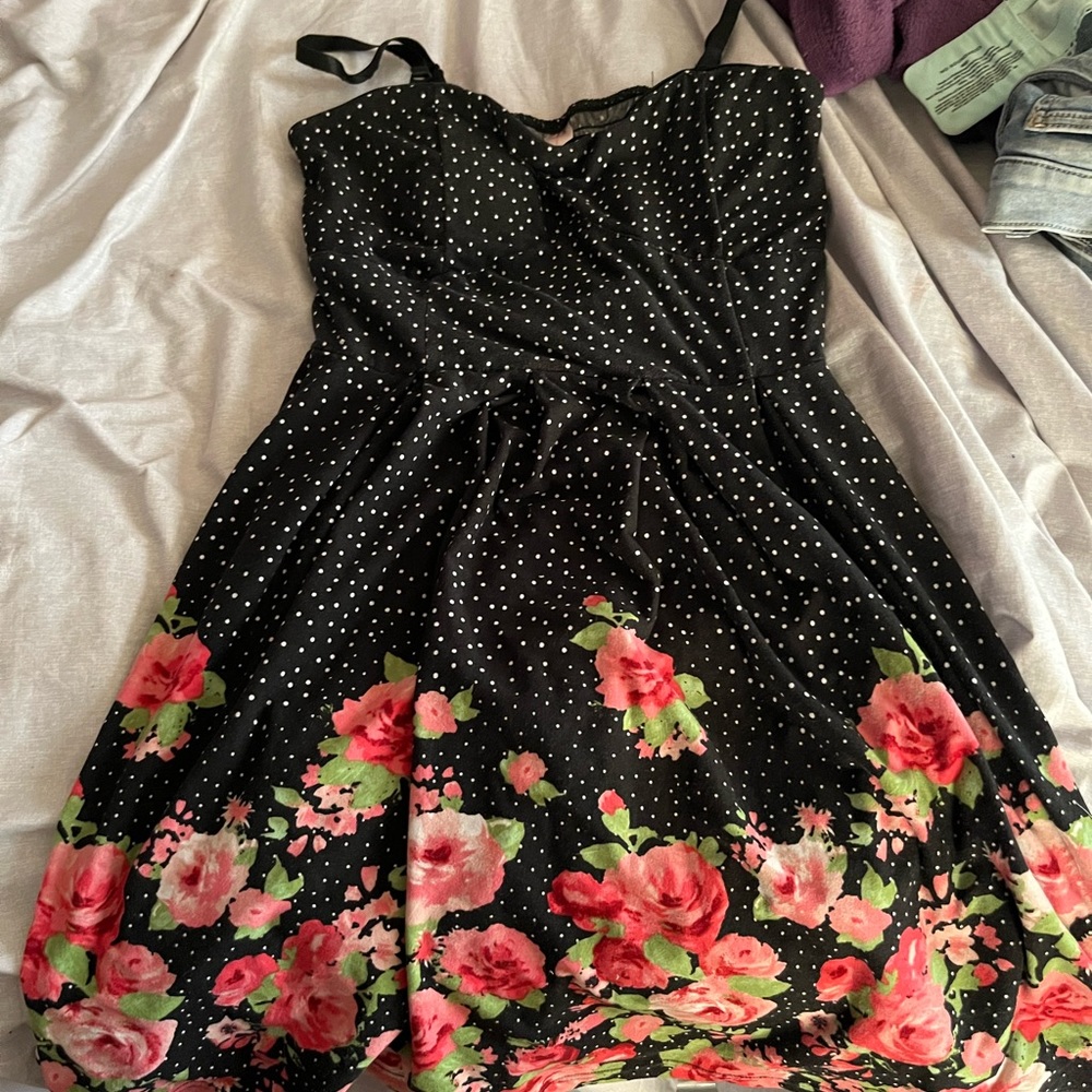 Black and white polkadotted dress with flowers on the bottom.